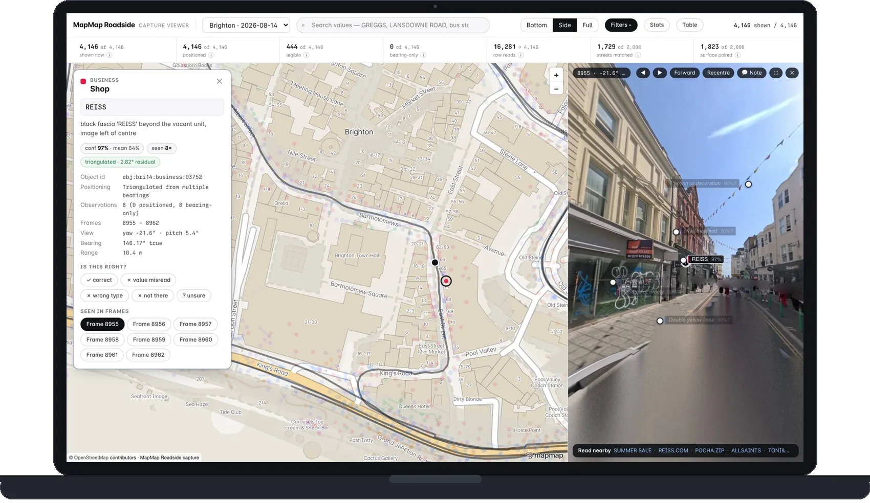 A laptop running the MapMap Roadside capture viewer on the Brighton pass: the record card for a shopfront open beside the map, read from the 360 frame on the right where the fascia carries its own reading chip · © OpenStreetMap contributors © OpenMapTiles